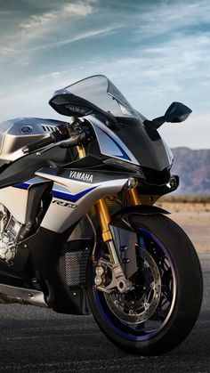 a white and blue motorcycle parked on the street