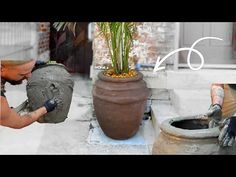 a man is using cement to make a potted plant