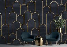 two chairs and a table in front of a black wall with gold lines on it