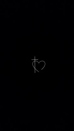 a heart with a cross drawn on it in the middle of a black background,