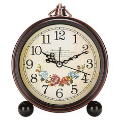 an antique style alarm clock with flowers on the face and numbers painted on the sides