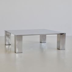 a white table sitting on top of a white floor