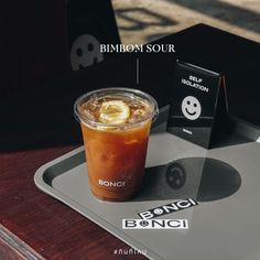 an iced drink is sitting on a tray next to a box with some sort of information