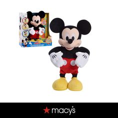 the mickey mouse plush toy is next to its box