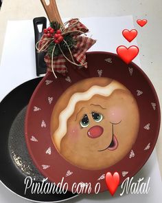 a plate with an image of a smiling face painted on the side and hearts around it