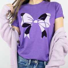 Score big with this trendy and fun Soccer Bow Tee. The bow with a soccer design makes it perfect for any soccer season and fan. Get ready to show off your love of the game with this playful and stylish shirt. Design is Printed Direct to Garment. See Size Guide for Bella Unisex Tee Casual Purple Game Day Top, Casual Purple Tops For Game Day, Casual Crew Neck Top With Bow Print, Casual Crew Neck Shirt For Cheerleading, White Casual Tops With Bow Print, Casual White Tops With Bow Print, Casual T-shirt With Bow Print And Crew Neck, Casual Purple T-shirt As Gift, Cotton Crew Neck T-shirt With Bow Print