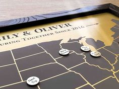 a framed map with pins on it that says family and oliver during together since 2016