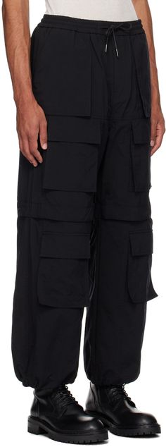 Nylon canvas cargo pants. · Drawstring at elasticized waistband · Four-pocket styling · Zip-fly · Flap pockets at front · Detachable panel at legs for alternative styling · Concealed bungee-style drawstring at cuffs · Press-stud tab at back knees Supplier color: Black Techwear Parachute Pants With Patch Pockets, Utility Parachute Pants With Functional Pockets, Functional Wide Leg Parachute Pants With Multiple Pockets, Functional Wide-leg Parachute Pants With Multiple Pockets, Utility Nylon Pants With Multiple Pockets, Utility Nylon Pants With Cargo Pockets, Wide Leg Nylon Cargo Pants With Cargo Pockets, Wide Leg Nylon Cargo Pants With Pockets, Nylon Cargo Pants With Hip Pockets