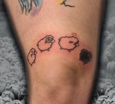 a tattoo on the leg of a person with sheep