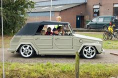 an old car with four people in it