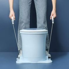 a person standing on top of a toilet with two handles attached to the seat and legs