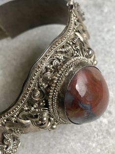 "Old Asian Doubble Dragon 900 Silver Red Marbled Agate Vintage Bracelet marked 90% near the Clasp. weighs 30g. 1 1/2\" wide At the widest The inside Circumstance is 7 1/2\". This bracelet is beautiful and does show age, please view pictures carefully for they are a large part of the description" Unique Red Gemstone Bracelet, Unique Red Gemstone Bracelets, Silver Agate Gemstone Cuff Bracelet, Vintage Red Gemstone Bracelets, Traditional Agate Bracelet, Traditional Agate Jewelry For Collectors, Traditional Agate Bracelet Jewelry, Traditional Gemstone Cuff Bracelet, Artisan Gemstone Bracelets