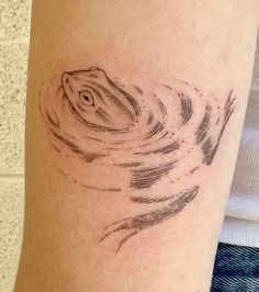 a woman's arm with a tattoo on it that has a fish in the water