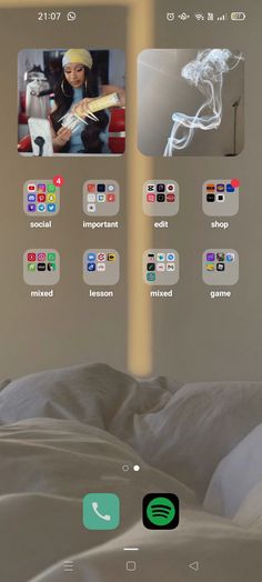 an image of a bed with many different app icons on the screen and in the background