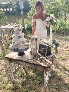 a woman standing next to a table filled with cakes