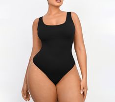 Featuring a low-back design that pairs perfectly with backless dresses, this smoothing bodysuit also features chest support and smoothing at the tummy to provide a lifted and flattering appearance. From Shapellx. Solid Color Smoothing Shapewear Bodysuit, High Cut Solid Shapewear With Lined Body, Shaping Scoop Neck Bodysuit, Shapewear Bodysuit With Scoop Neck, Elegant Sculpting Backless Bodysuit, Smoothing One-piece Leotard, Solid Backless Seamless Shapewear, Smoothing Scoop Neck Shapewear, Scoop Neck Shapewear With Lined Body