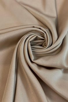 a close up shot of the fabric on a plain tan colored shirting material, which is very soft and smooth