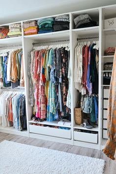 an organized closet with clothes hanging on the shelves and drawers in front of each other