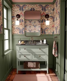 a bathroom with green walls and wood flooring has a large mirror above the sink