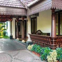 the front porch of a house with wooden railings