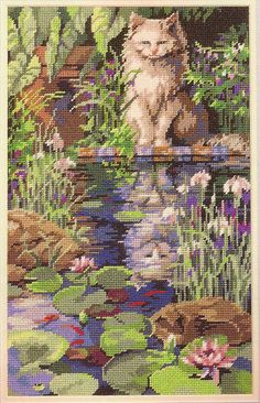 a cat is sitting on the edge of a pond with lily pads and water lilies