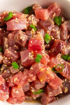 a white bowl filled with meat and veggies