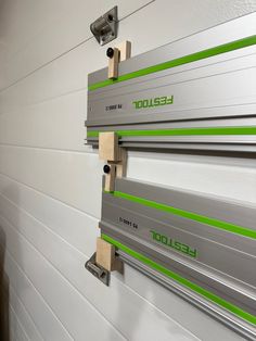 the side of a garage door with green and white trim on it's sides