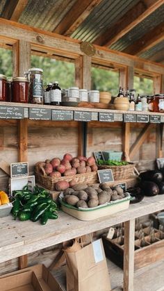 an outdoor market with various fruits and vegetables on the shelves, along with other items