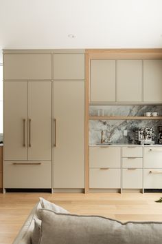 a living room filled with furniture and cabinets