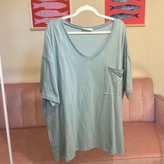 Oversized Boyfriend Tee With Front Pocket And Raw Edge! This Is Such A Fun Minty Green Color! Material: 100% Cotton Mega Oversized!! Small: Medium: Ptp 30” Length 30” Large: Ptp 31” Length 30” Extra Large: Ptp: 32” Length 31” 1x: Ptp 33.5” Length 32” 2x: Ptp 33” Length 32” 3x: Ptp 34” Length 32” Oversized Short Sleeve Tops For Loungewear, Oversized Soft-washed Tops For Day Out, Green Relaxed Fit T-shirt For Day Out, Oversized Graphic Tee For Loungewear, Oversized Short Sleeve Top For Summer, Oversized Basic Short Sleeve Top For Summer, Oversized Casual Short Sleeve Top For Loungewear, Oversized Green Soft-washed Tops, Oversized V-neck T-shirt For Spring