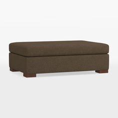 a brown ottoman sitting on top of a white floor