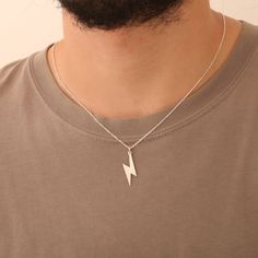 This sleek silver lightning bolt necklace is a bold symbol of power and energy ⚡. Its minimalist design makes it a versatile piece, perfect as a unique birthday or Christmas gift for him 🎁. Whether he's into nature, mythology, or simply wants a standout accessory, this thunderbolt pendant is sure to impress. High-quality silver lightning bolt pendant Symbolizes energy, power, and strength ⚡ Lightweight and comfortable for everyday wear Ideal as a birthday or Christmas gift 🎄 Minimalist design Nature Mythology, Lightning Necklace, Lightning Bolt Necklace, Energy Power, Jewelry Minimalist, Christmas Gifts For Him, Necklace For Men, Lightning Bolt, Gold Plated Necklace