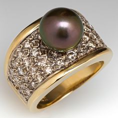 This striking ring is centered with one (1), post set, cultured Tahitian pearl. The top half of the ring is accented with fifty (50), bead set, round brilliant cut diamonds. The ring measures 13.6mm at the top, rises 11.8mm above the finger, tapering to 4.4mm wide and 1.1mm thick at the base of the shank. This ring is currently a size 4.5. Luxury Yellow Gold Rings With Pearl Drop, Luxury Yellow Gold Pearl Drop Ring, Luxury Exquisite Pearl Ring With Round Cut, Luxury Yellow Gold Pearl Ring For Everyday, Luxury Yellow Gold Timeless Pearl Ring, Luxury Halo Setting Pearl Ring For Women, Luxury Timeless Yellow Gold Pearl Ring, Luxury Exquisite Round Cut Pearl Ring, Luxury Elegant Tahitian Pearl Rings