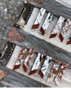 several pieces of cowhide are hanging on wooden boards