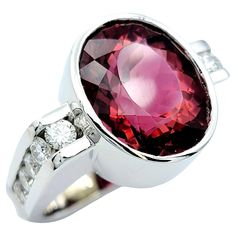 Ring size: 4.5 Elevate your fine jewelry collection with this stunning Scott Gauthier rubellite tourmaline & diamond ring. This contemporary masterpiece effortlessly blends sophistication with modern design, making it a true showstopper. At the heart of this ring, you'll find a captivating oval rubellite tourmaline, a vibrant gemstone that radiates a rich, deep pink hue. This stunning centerpiece is expertly bezel set in 14 karat white gold, allowing the pink to really pop. Flanking the rubellit Multi Gemstone Ring Jtv, Gia Certified Tourmaline Rings For Formal Occasions, Fine Jewelry Tourmaline Rings With Brilliant Cut, Oval Tourmaline White Gold Rings, Luxury Oval Tourmaline Ring, Modern Oval Gia Certified Rings, Modern Gia Certified Oval Rings, Luxury Polished Tourmaline Rings, Luxury Oval Tourmaline Jewelry