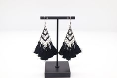 The Silver and Black Tassel Earrings showcase a striking contrast with their silver base and stylish black tassels, creating a chic and contemporary look. These earrings effortlessly blend sophistication with a touch of edge, making them a versatile accessory to elevate your fashion ensemble. Black Fringe Dangle Chandelier Earrings, Elegant Black Fringe Chandelier Earrings, Black Fringe Tassel Drop Earrings, Elegant Black Dangle Tassel Earrings, Elegant Black Tassel Drop Earrings, Black Tassel Earrings For Evening, Black Tassel Drop Earrings For Evening, Black Fringe Drop Earrings, Trendy Black Fringe Jewelry