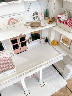 a doll house with all the furniture and accessories in it's white, wooden floor