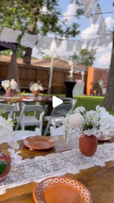 a table with plates and flowers on it