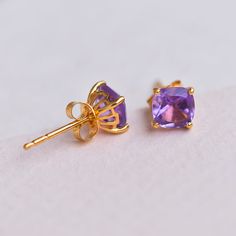 Owning an Amethyst is a symbol of royalty. This February birthstone is believed to strengthen relationships and give courage. Ancient Greeks thought that the amethyst guarded against intoxication. Amethyst derived its name from amethystos, a Greek word meaning “sober.” Gemstone - Amethyst - Not TreatedMetal -Solid 10K Yellow Gold & Gold Wt. - 0.66 gmStone Size - Amethyst 1.60 Ct. 6 x 6 mm, Product Weight - 0.98 gmSolid 10K gold quality stamp Distinctive and captivating qualities of natural stone Purple Spiritual Gemstones For Anniversary, Spiritual Purple Gemstones For Anniversary, Purple Amethyst Earrings With Prong Setting, Purple Amethyst Birthstone Earrings, Purple Earrings With Prong Setting For Gift, Amethyst Birthstone Earrings For Gift, Amethyst Birthstone Earrings As A Gift, Yellow Gold Stud Earrings, Word Meaning