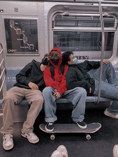 two people are sleeping on a subway bench