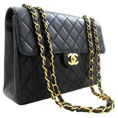 An authentic CHANEL Classic Large 11" Chain Shoulder Bag Flap Black made of black Lambskin. The color is Black. The outside material is Leather. The pattern is Solid. This item is Vintage / Classic. The year of manufacture would be 1996-1997. Conditions & Ratings Outside material: Lambskin Color: Black Closure: Turn Lock Hardware and chain: Gold-Tone Made in France Serial sticker: Attached Comes with: Dust bag, Box Bag Overall: 8 of 10 - The outside is in excellent condition with minimal signs o Vintage Chanel Bag, Structured Shoulder, Chanel Brand, Chanel Flap Bag, Chanel Mini, Chain Gold, Box Bag, Chanel Black, Black Queen