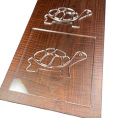 a wooden cutting board with a cut out of a turtle on it