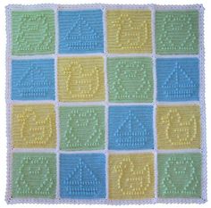 a crocheted afghan with blue, yellow and green squares on the bottom that have words written in different languages