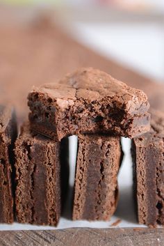 chocolate brownies stacked on top of each other with one cut in half and the rest partially eaten