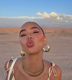 a woman sticking her tongue out in the desert