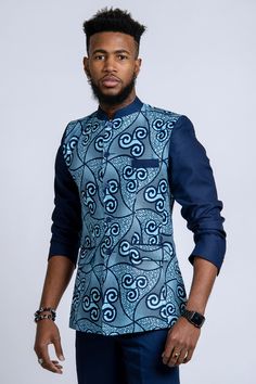 This design of African blazer for men is called Abacost. Created by President MObutu in 1972, it is a mixture of western suit and shirt.  Get a unique style with Afrilege's Abacost. More designs at afrilege.com Blue Long Sleeve Sets With Set-in Sleeves, Formal Blue Nehru Jacket With Stand Collar, Blue Formal Nehru Jacket With Stand Collar, Fitted Blue Nehru Jacket For Semi-formal Occasions, Blue Fitted Nehru Jacket For Semi-formal Occasions, Tailored Blue Nehru Jacket, Tailored Blue Nehru Jacket With Long Sleeves, Blue Tailored Long Sleeve Nehru Jacket, African Male Suits