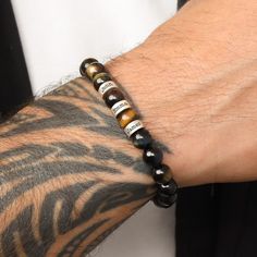 Mysterious and powerful, it is believed that the Tiger's Eye stone protects the one wearing it and enabling them to see everything. A stone of courage, prosperity, and good fortune, the Tiger's Eye gemstone, can be used on any occasion. The engraved spheres will give this bracelet an even more intriguing look and genuine meaning. Place on this stylish green Tiger's Eye bracelet the names of loved ones who help to keep you steady and calm. Green Tiger Eye Bracelet, Green Tiger Eye, Tiger Eye Bracelet, Tigers Eye Gemstone, Tiger Eye Beads, Eye Beads, Tiger Eye Stone, Eye Bracelet, Eye Stone