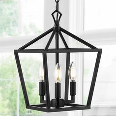 a black chandelier with three lights hanging from it