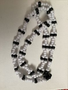 a white and black beaded necklace on display