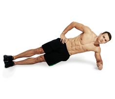 a shirtless man laying on the ground with his legs spread out and one leg in the air